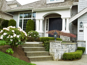 A professional roofer in Morrisville inspecting a roof for damage, with a ladder and tools in the foreground.
