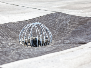 A commercial building with a well-maintained roof an ddrainage system in Clayton, North Carolina