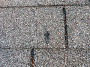 Expert roofer in Clayton NC inspecting a roof to avoid common mistakes.